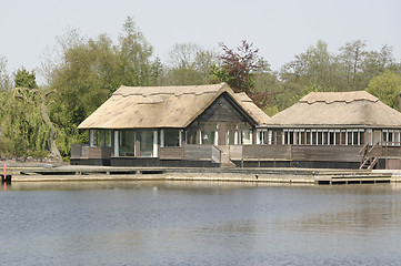 Image showing wooden thatched cottages