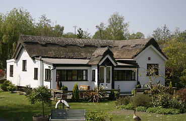 Image showing thatched cottage with a conservatory