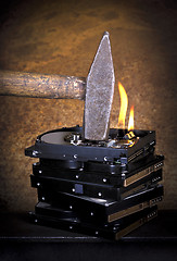 Image showing hammer and burning hard disks