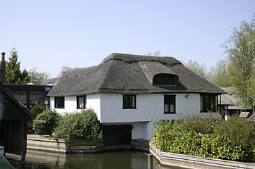 Image showing thatched cottage next to the river