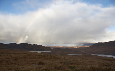 Image showing atmospheric scottish scenery with rainbow and clouds