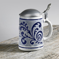 Image showing blue decorated stein on wooden surface