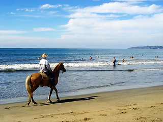 Image showing Lone rider on the beach