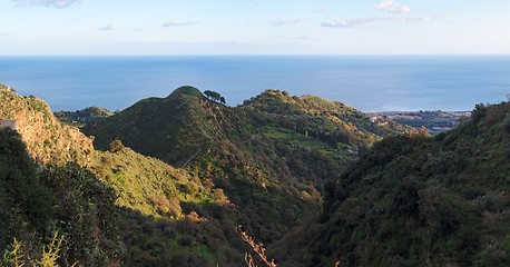 Image showing Mediterranean hills near the sea coast at sunset 