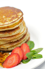 Image showing Pancake Fritters with strawberry and leaflets of mint
