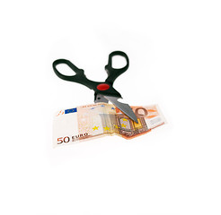 Image showing scissors cutting euro bill  isolated on white