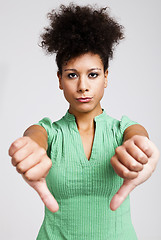 Image showing Beautiful woman with thumbs down