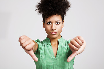 Image showing Beautiful woman with thumbs down