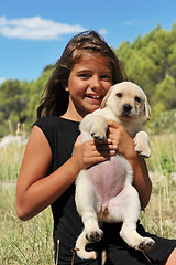 Image showing puppy labrador and smiling girl