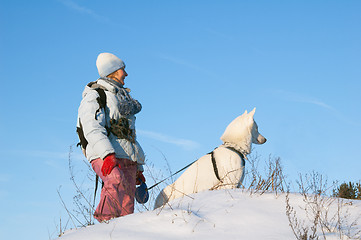 Image showing The woman with a dog in winter on walk