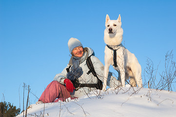 Image showing The woman with a dog in winter on walk