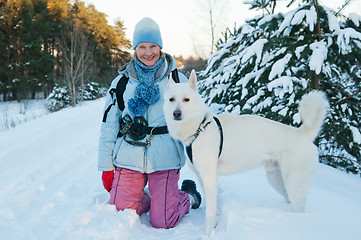 Image showing The woman with a dog in winter on walk