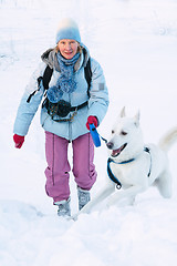 Image showing The woman with a dog in winter on walk