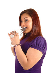 Image showing Girl eating chocolate bar.