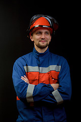 Image showing The worker in overalls and a helmet