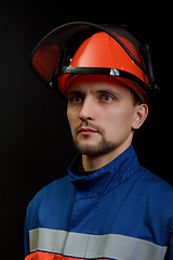 Image showing The worker in overalls and a helmet