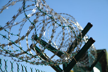 Image showing barbed wire against blue sky 