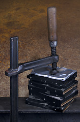 Image showing clamp pressing on stack of hard drives