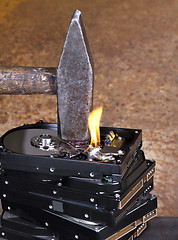 Image showing hammer on stack of hard disk