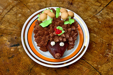 Image showing Cake in the form of a hedgehog on a wooden stand