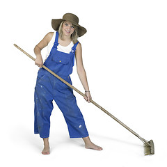 Image showing cute girl dressed in workwear while raking