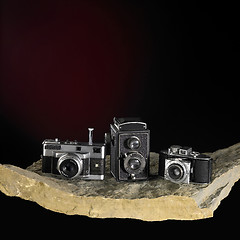 Image showing nostalgic cameras on stone surface