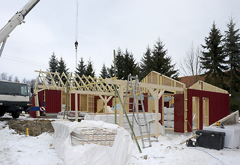 Image showing wooden house construction at winter time