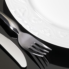 Image showing porcelain dinnerware with fork and knife