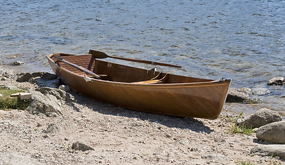 Image showing wooden rowboat waterside