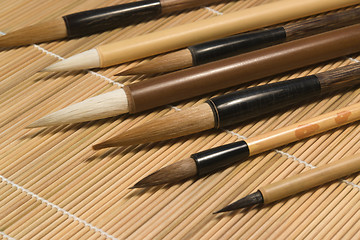 Image showing chinese brushes on wooden mat detail