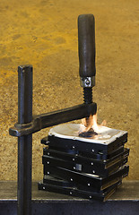 Image showing burning vise and hard disks