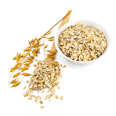 Image showing Rolled oats in a bowl and spoon