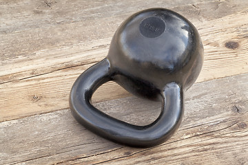 Image showing black kettlebell on wood deck