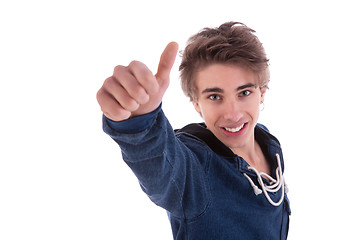 Image showing young man smiling, with thumb up, isolated on white