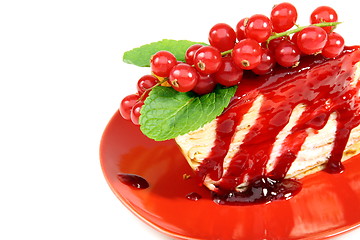 Image showing Crepe cake with berry sauce closeup.