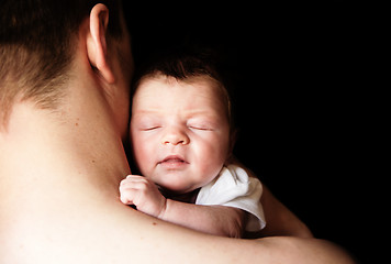 Image showing infant in the arms of his father