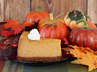 Image showing Pumpkin cheesecake in autumn setting