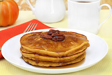 Image showing Pumpkin pancakes with pecans and syrup.