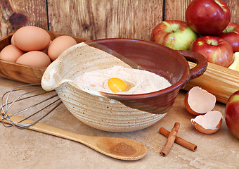 Image showing Baking ingredients including flour, apples and supplies.