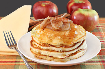 Image showing Stacked pancakes with baked apples topping.