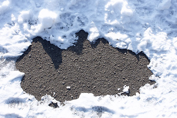 Image showing Asphalt between snow drifts