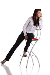 Image showing Girl sitting on the bar chair