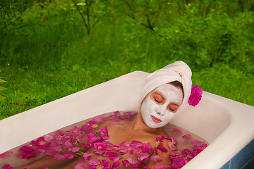 Image showing beautiful woman enjoying floral bath