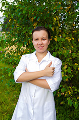 Image showing cheerful smiling woman doctor outdoors