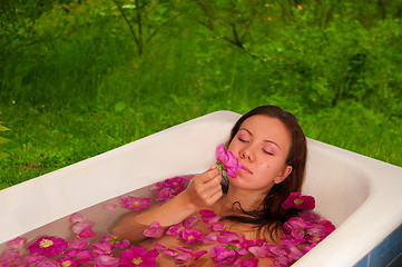 Image showing beautiful woman enjoying floral bath