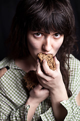 Image showing beggar woman eating bread