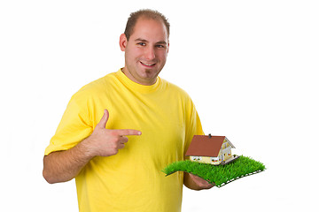 Image showing Young man with model house