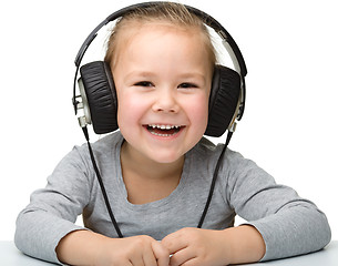 Image showing Cute girl enjoying music using headphones