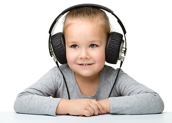 Image showing Cute girl enjoying music using headphones