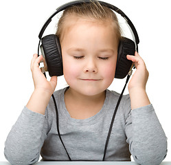 Image showing Cute girl enjoying music using headphones